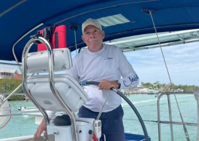 Capt Rick at the helm - Sun Sailing Charters