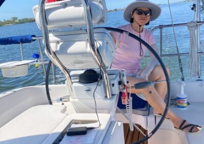 First Mate Alice at the helm - Sun Sailing Charters